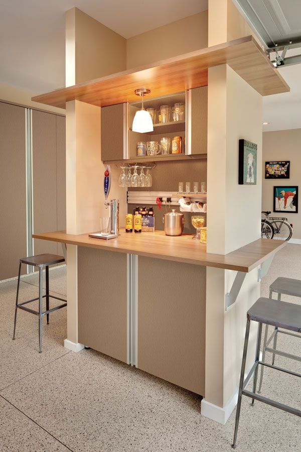 A kitchen with a bar and stools in it