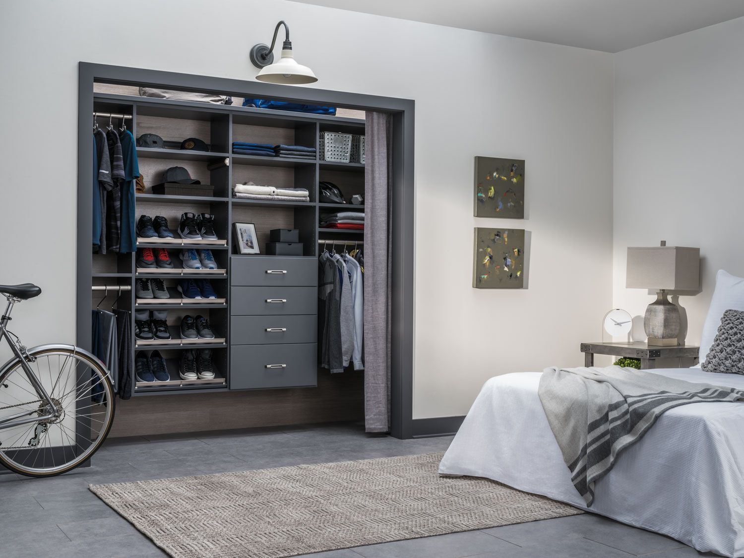 A bedroom with a bed a closet and a bicycle