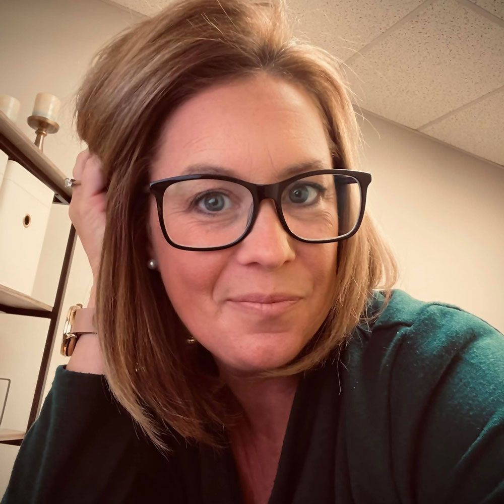 A silhouette of a person in a circle on a gray background.