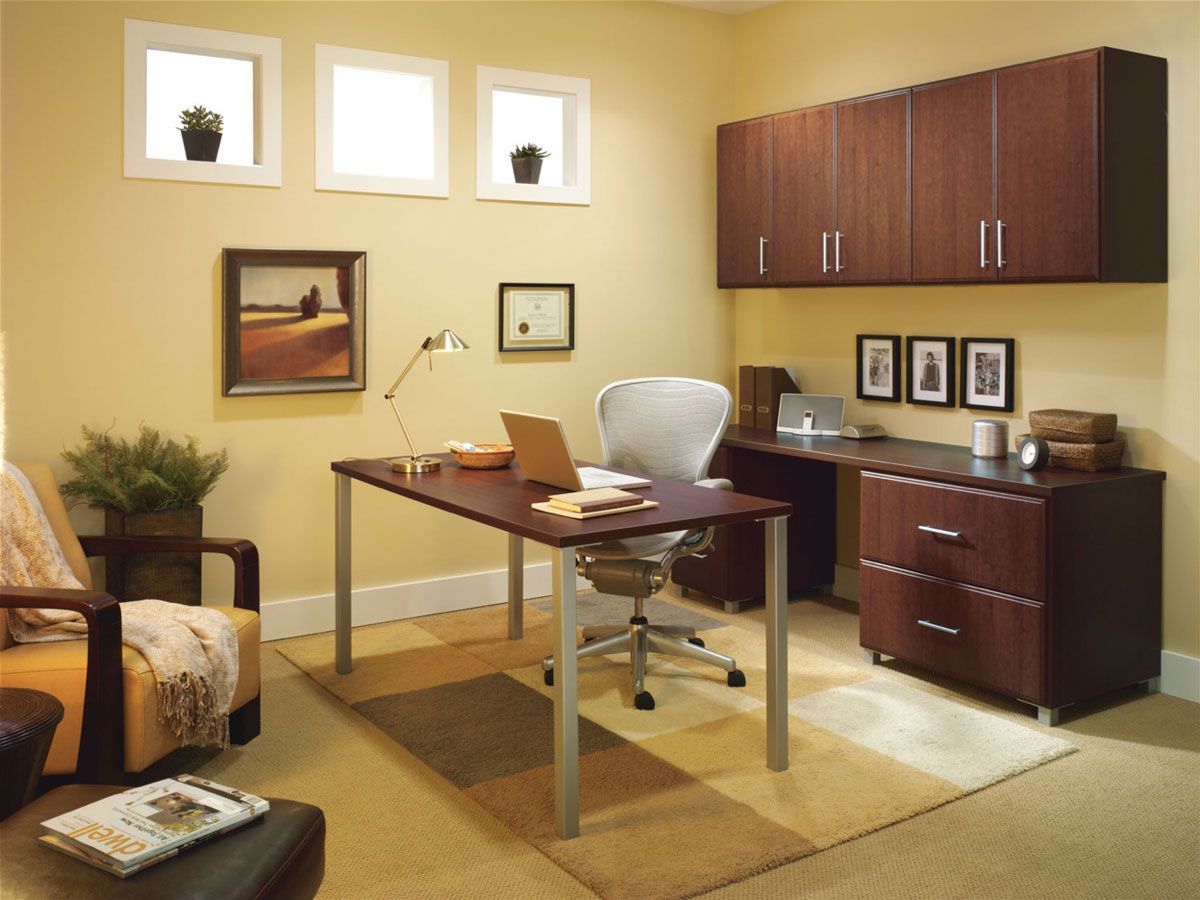 A home office with a desk chair and a laptop