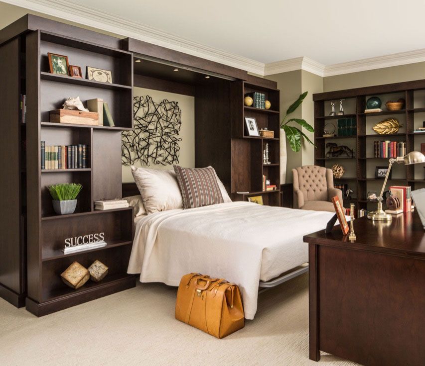 A bedroom with a bed and a desk with a sign that says success