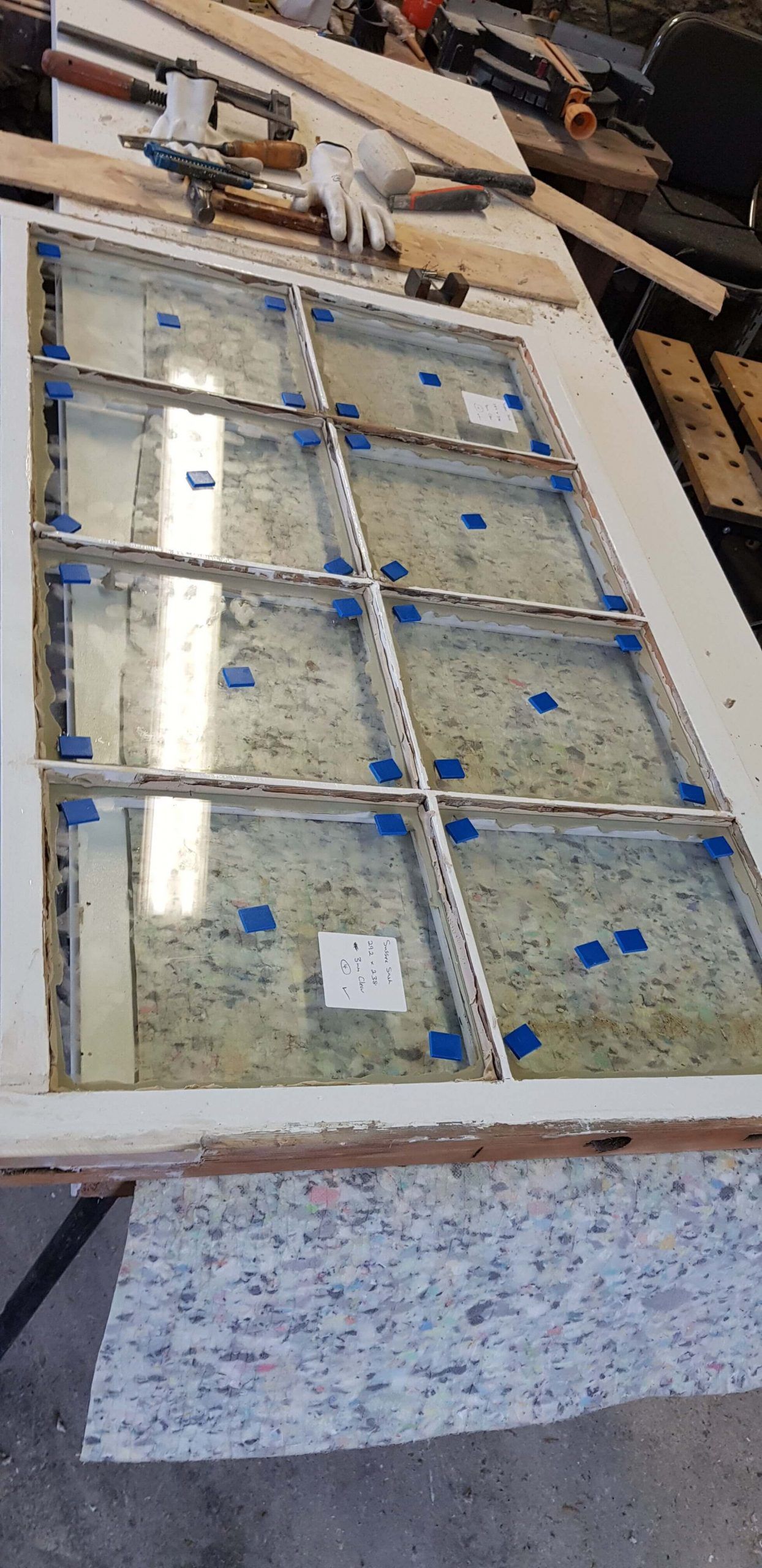 A piece of glass is sitting on top of a wooden table.