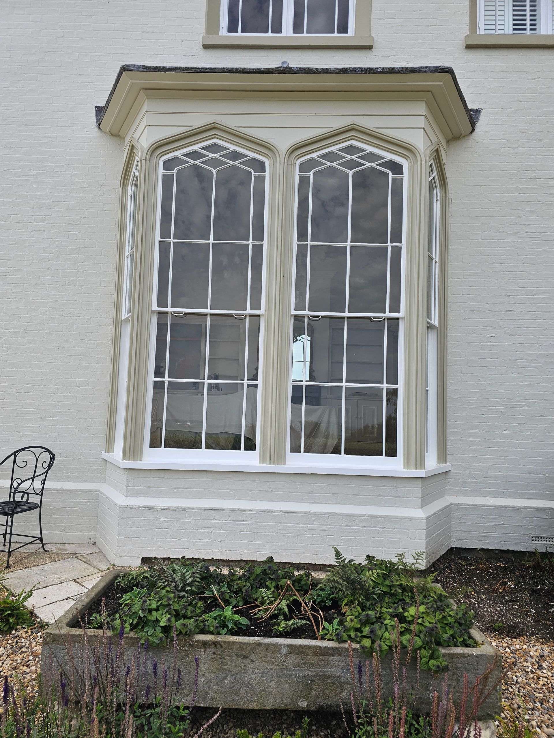 A white brick building with a large bay window