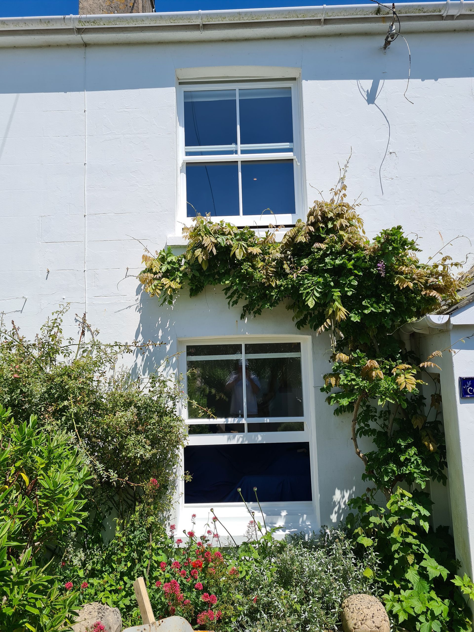 A white house with a blue door and a blue window