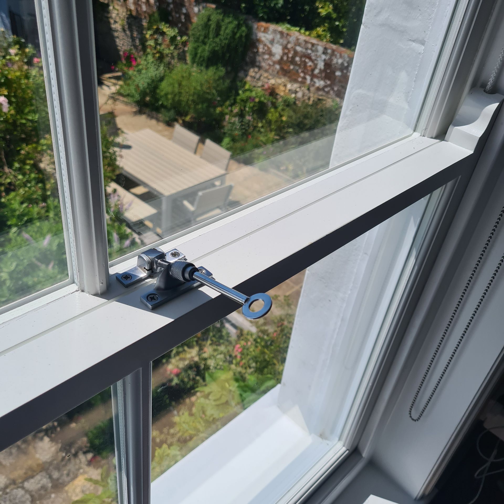 A close up of a window with a key in it.
