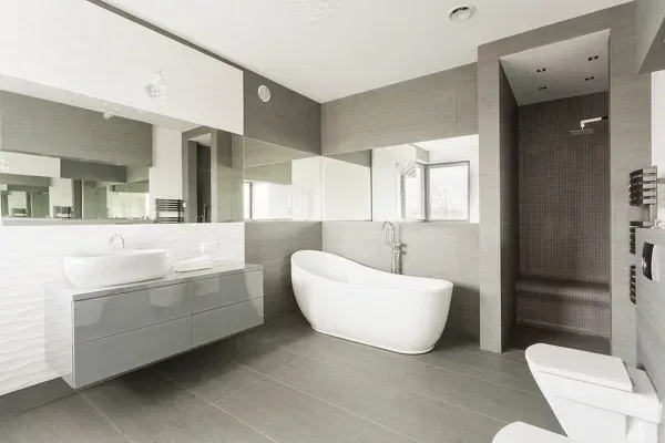 A bathroom with a bathtub , toilet , sink and mirror.