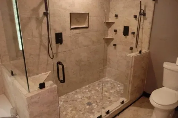A bathroom with a walk in shower and a toilet