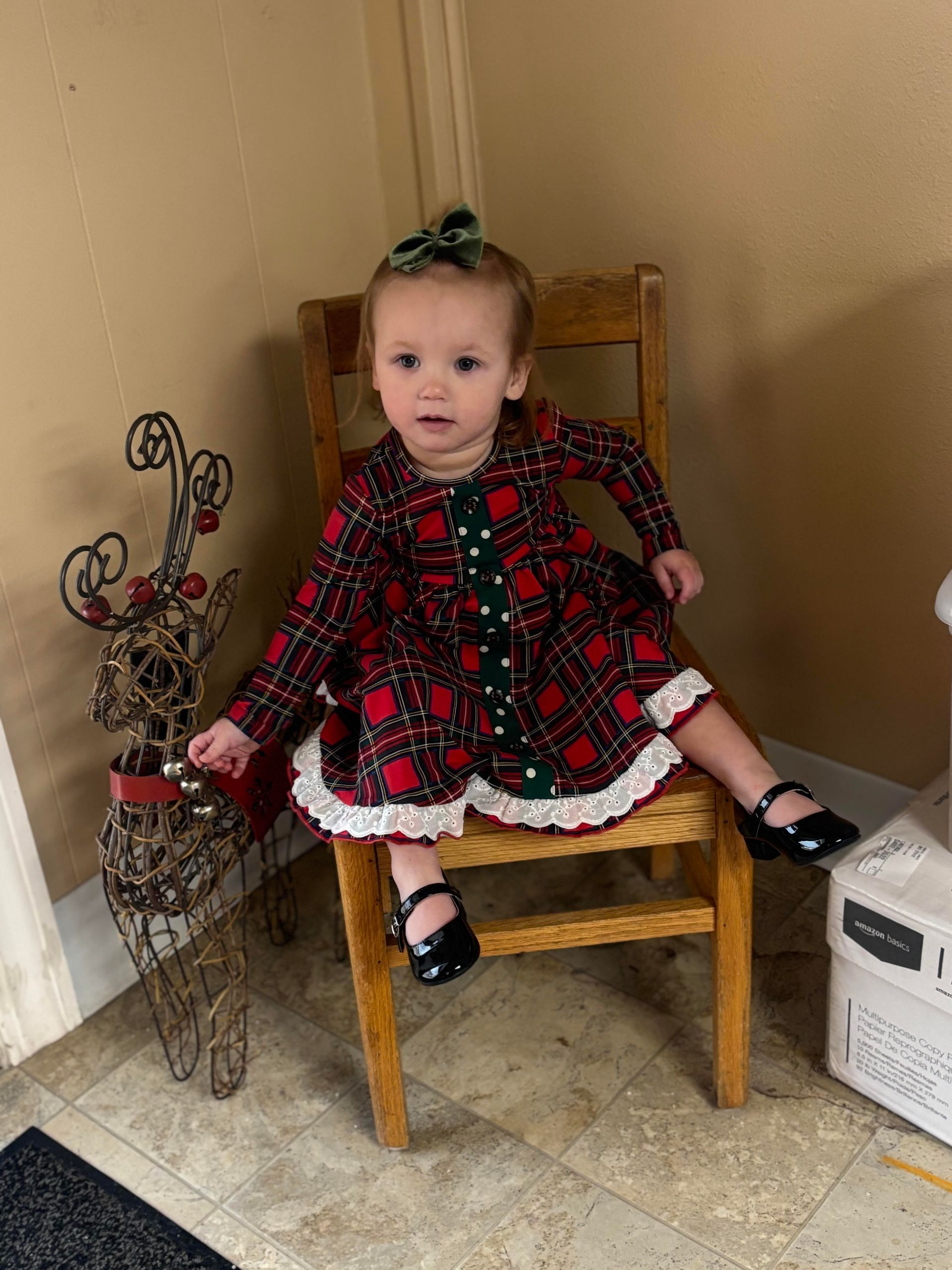 Two toddlers playing with pumpkin guts. One looks at the camera while the other looks down.
