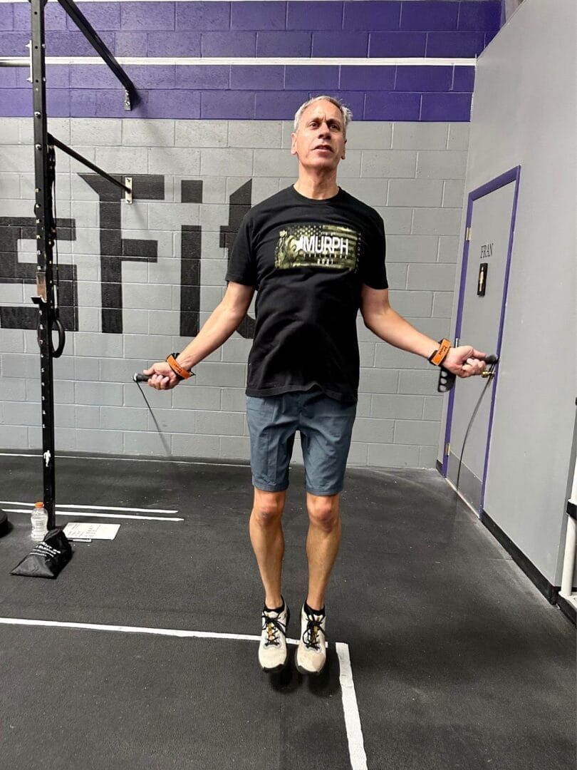 A man is jumping a jump rope in a gym.