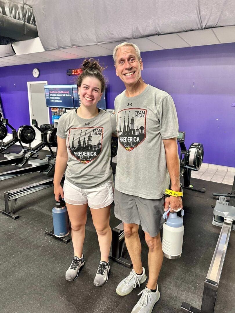 A man and a woman are posing for a picture in a gym.