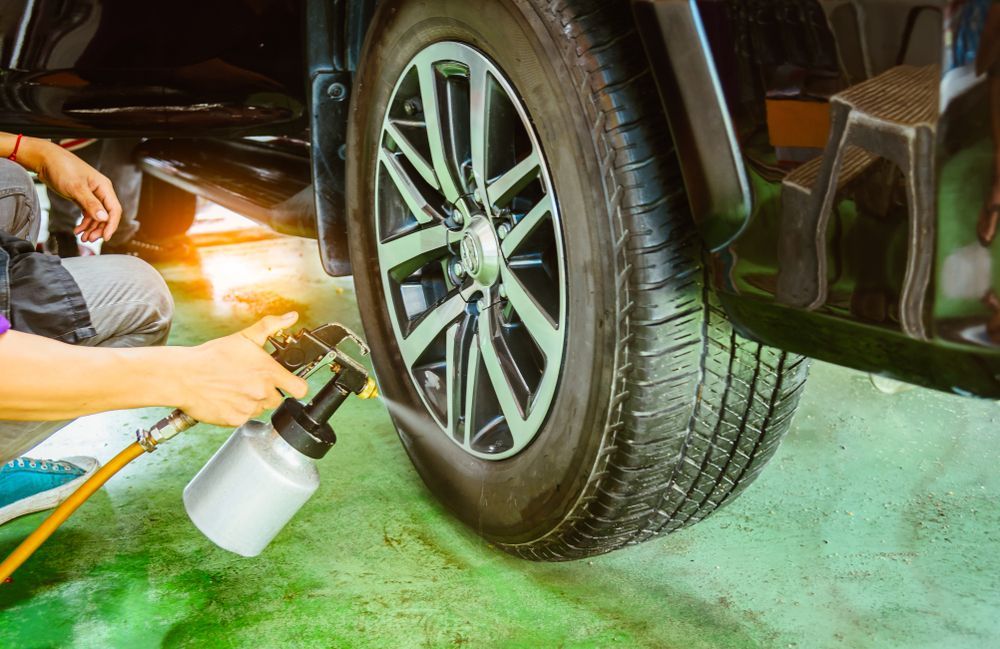 A Person is Spraying a Tire With a Spray Bottle — Sure Shot Sprayer Australia in Alice Springs, NT