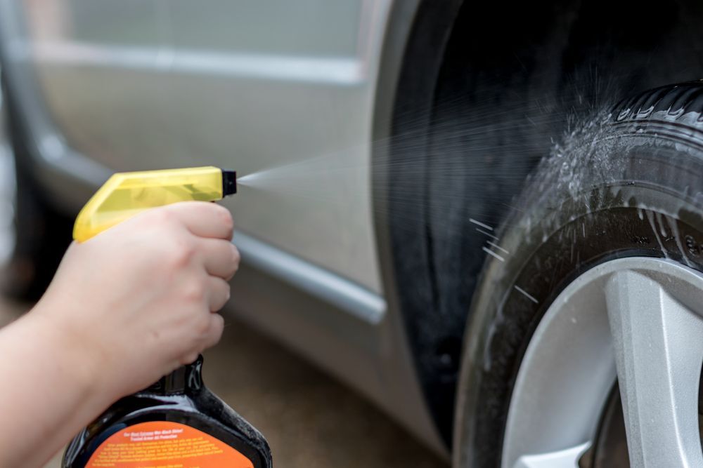 A Person is Spraying a Tire With a Spray Can — Sure Shot Sprayer Australia in Alice Springs, NT