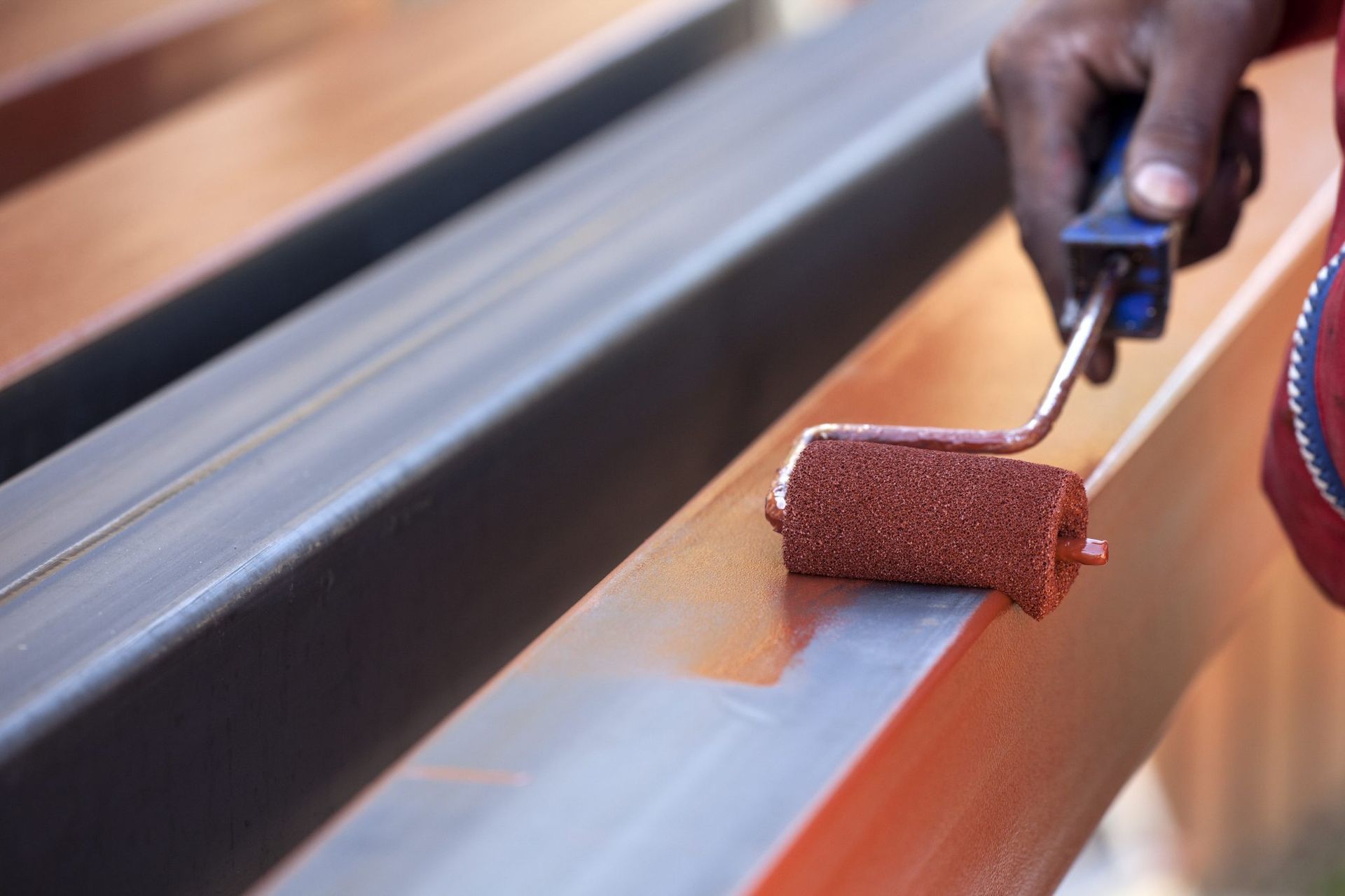 A man is using a drill to drill a hole in a wall.