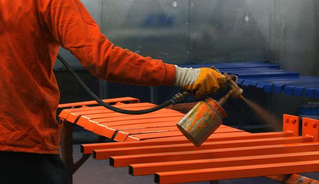 A man is working on a wall in a room.