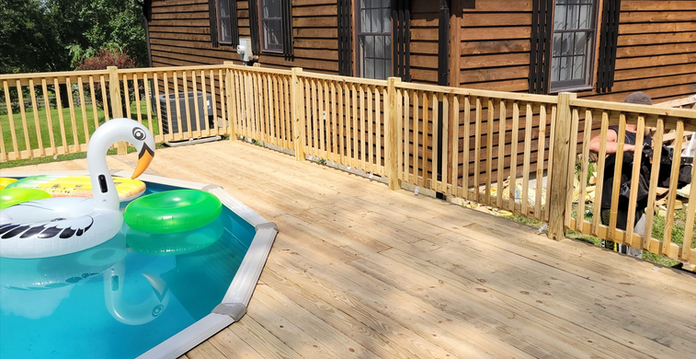 A Swan Float Is Floating In A Pool Next To A Wooden Deck - Owingsville, KY - Withrow Builders