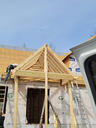 A Man Is Standing On A Ladder On Top Of A Wooden Structure - Owingsville, KY - Withrow Builders