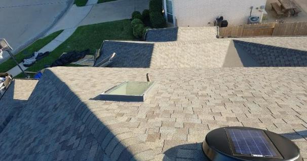 A roof with a skylight and a solar panel on it