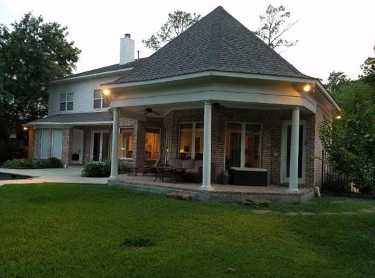 A large brick house with a large porch