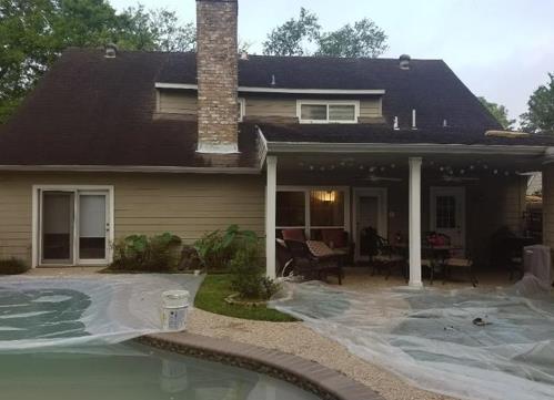 A house with a patio and a pool in front of it