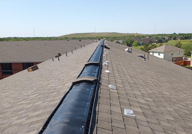 The roof of a building with a gutter on it