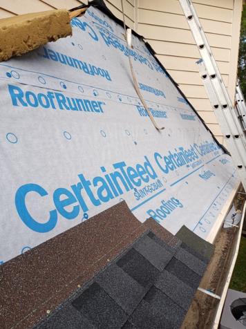 The roof of a house is being covered with roof runner.