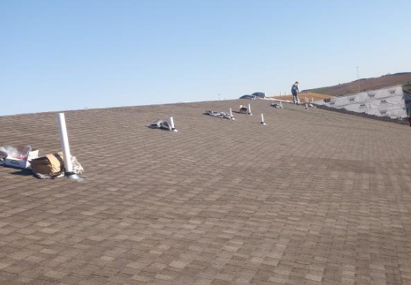A man is standing on the roof of a building.