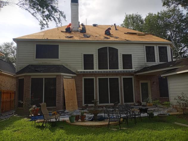 A large house with a lot of windows is being remodeled.
