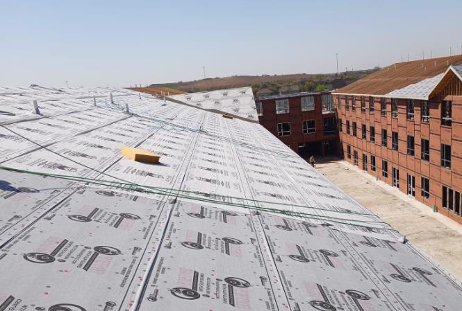 A large building with a roof that has a lot of shingles on it