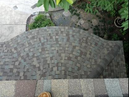 A staircase made of bricks is surrounded by trees and bushes.