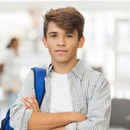 A young man with his arms crossed is wearing a blue backpack