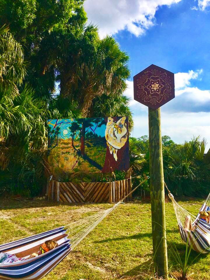 Bee Aware mural at the Okeechobee Music Festival. Created by heartspace art, this mural has a message about the importance of bees in our ecosystem. This photo is a close up on the lighting pillars.