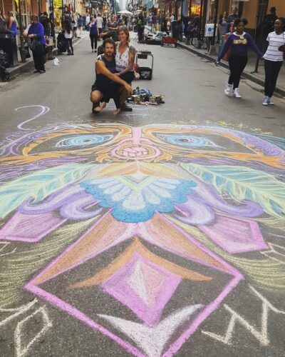 This image has Ian and Danielle by their freshly completed chalk art mural, entitled Feminine Mystique, created in New Orleans for the Women's March.