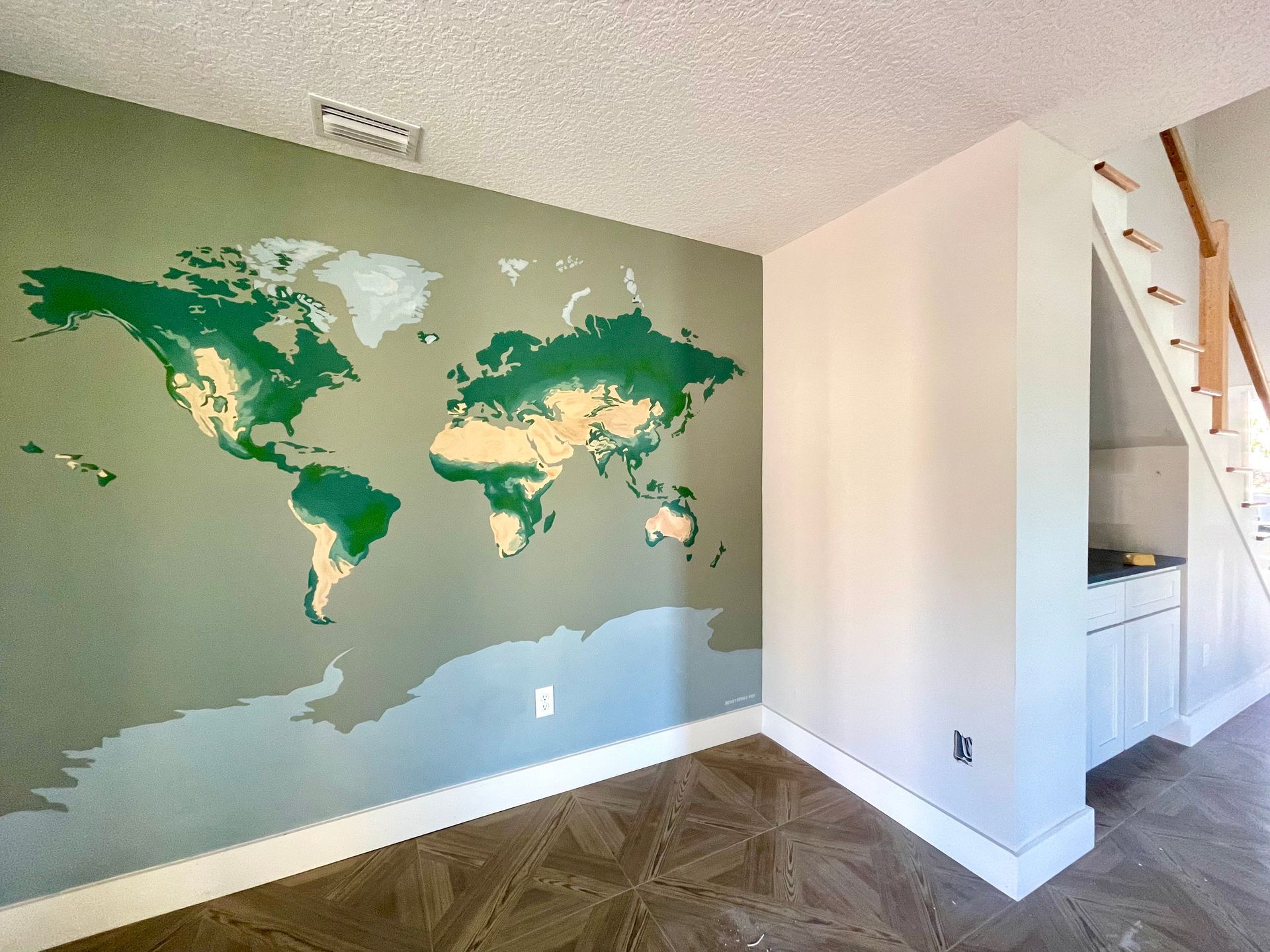 Accent wall mural painting of earth/globe, created for a new home construction in Green Cove Springs, Jacksonville, Florida.