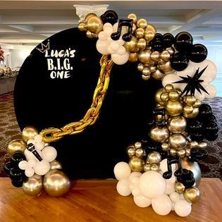 A bunch of balloons are sitting on top of a wooden floor.