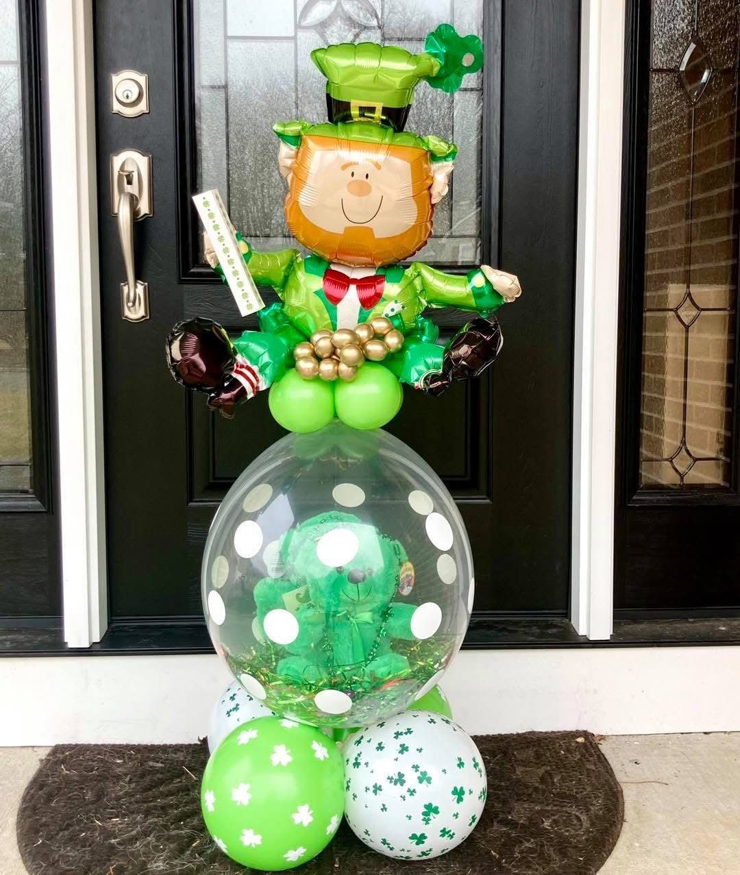 A welcome sign with balloons in front of a building