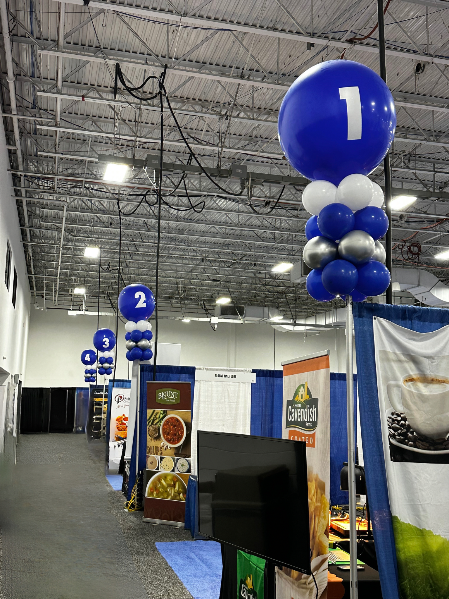 A row of blue and white balloons with the number 1 on them