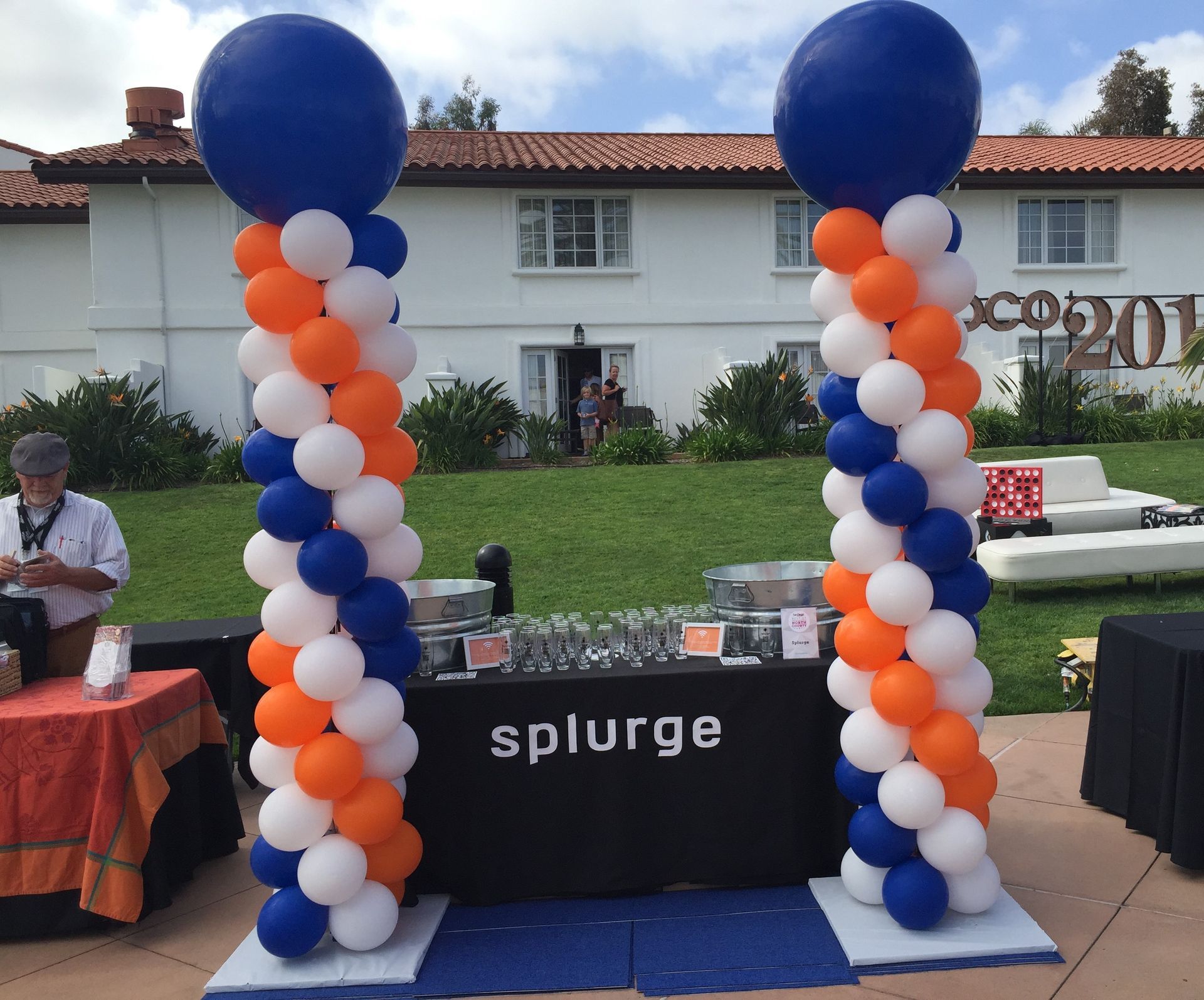 A table with balloons and a sign that says splurge