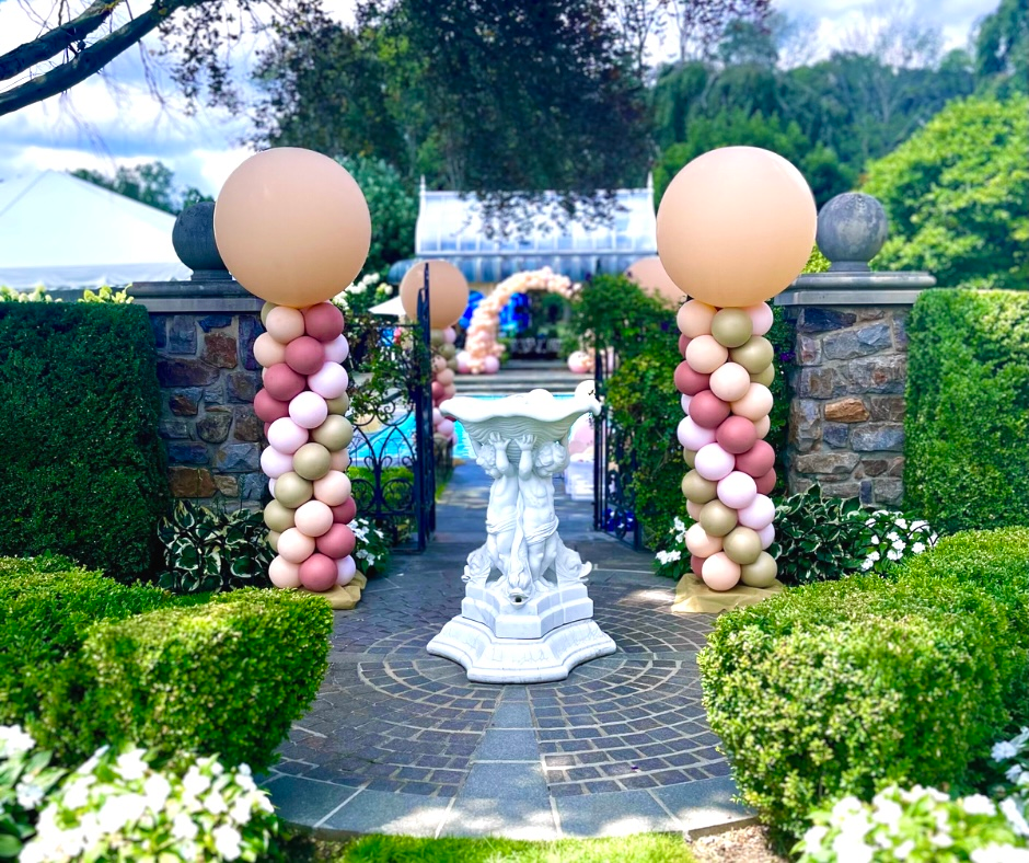 A garden filled with balloons and a fountain.