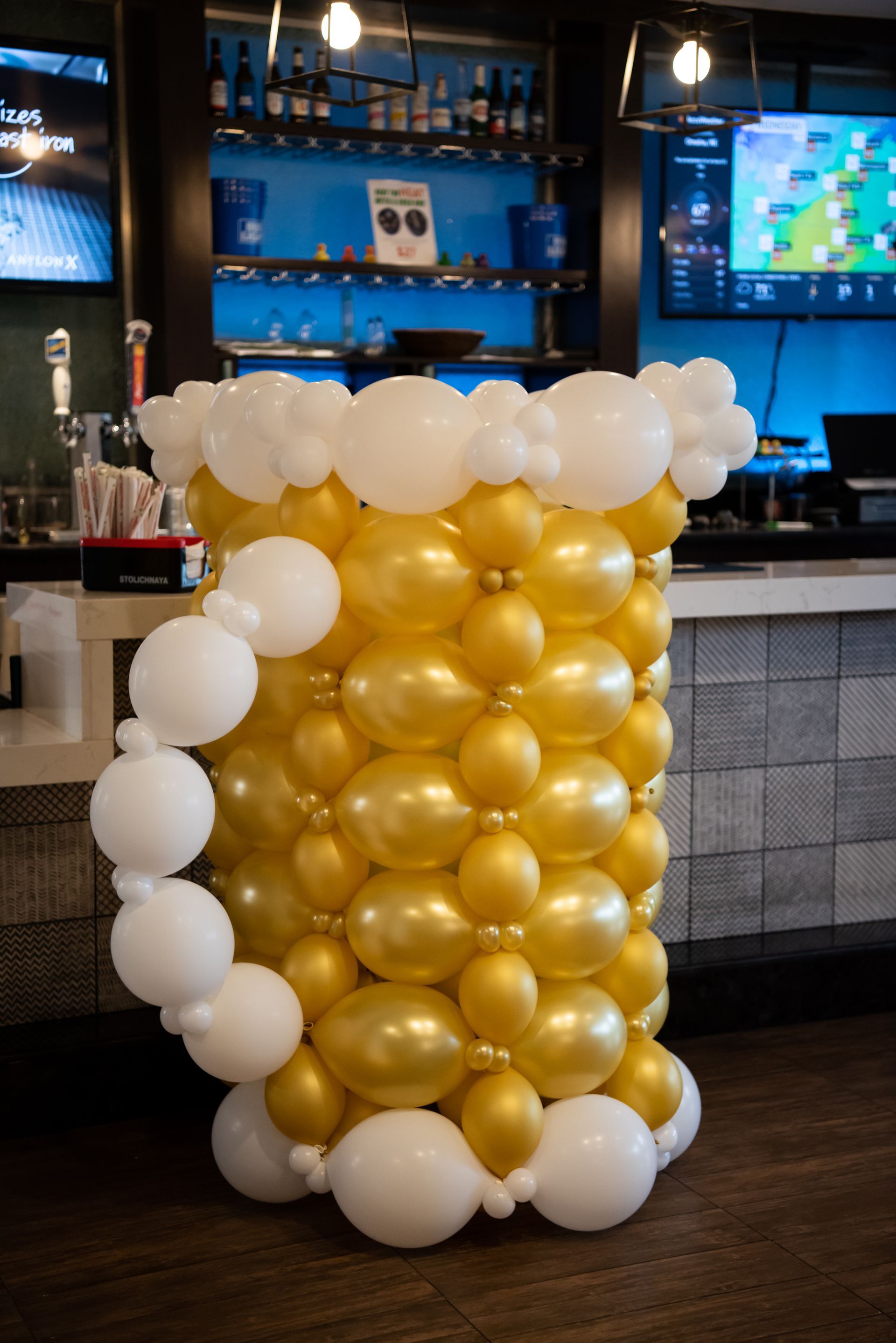 A beer mug made out of balloons in a bar.