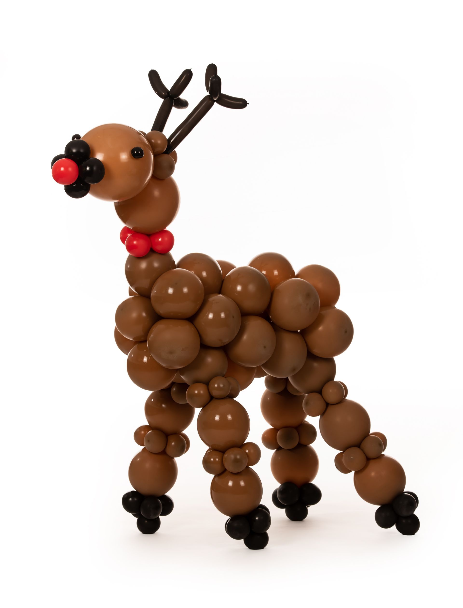 A reindeer made out of balloons with a red nose