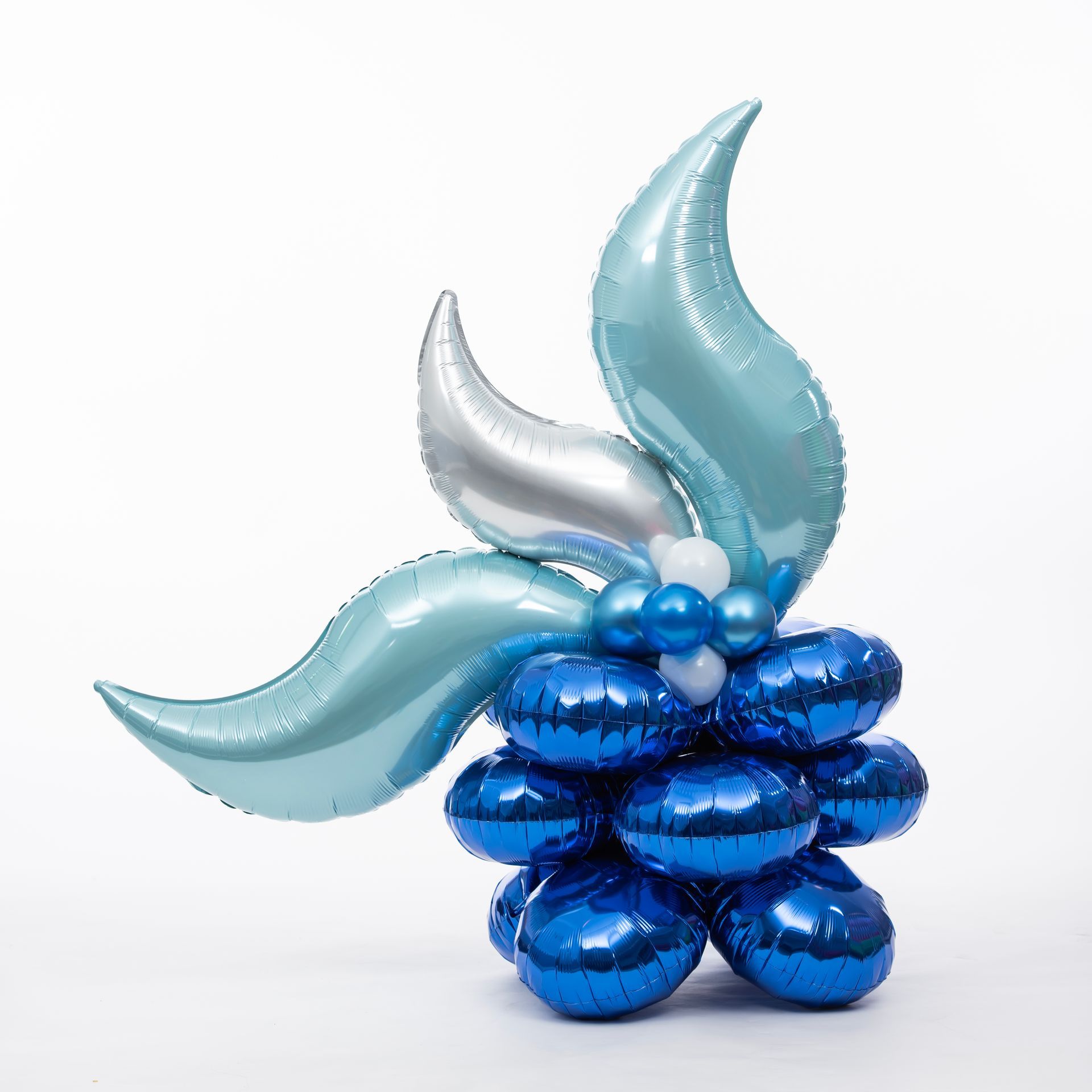 A bunch of blue balloons are stacked on top of each other