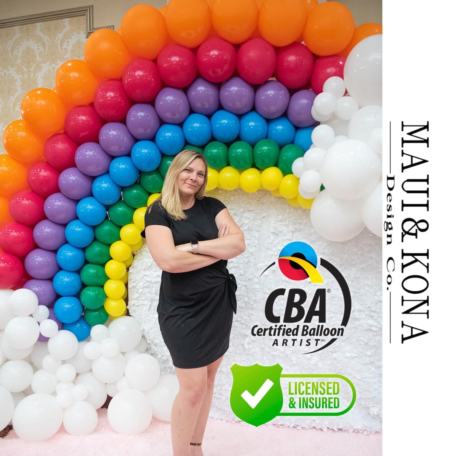 A woman is standing in front of a rainbow made of balloons