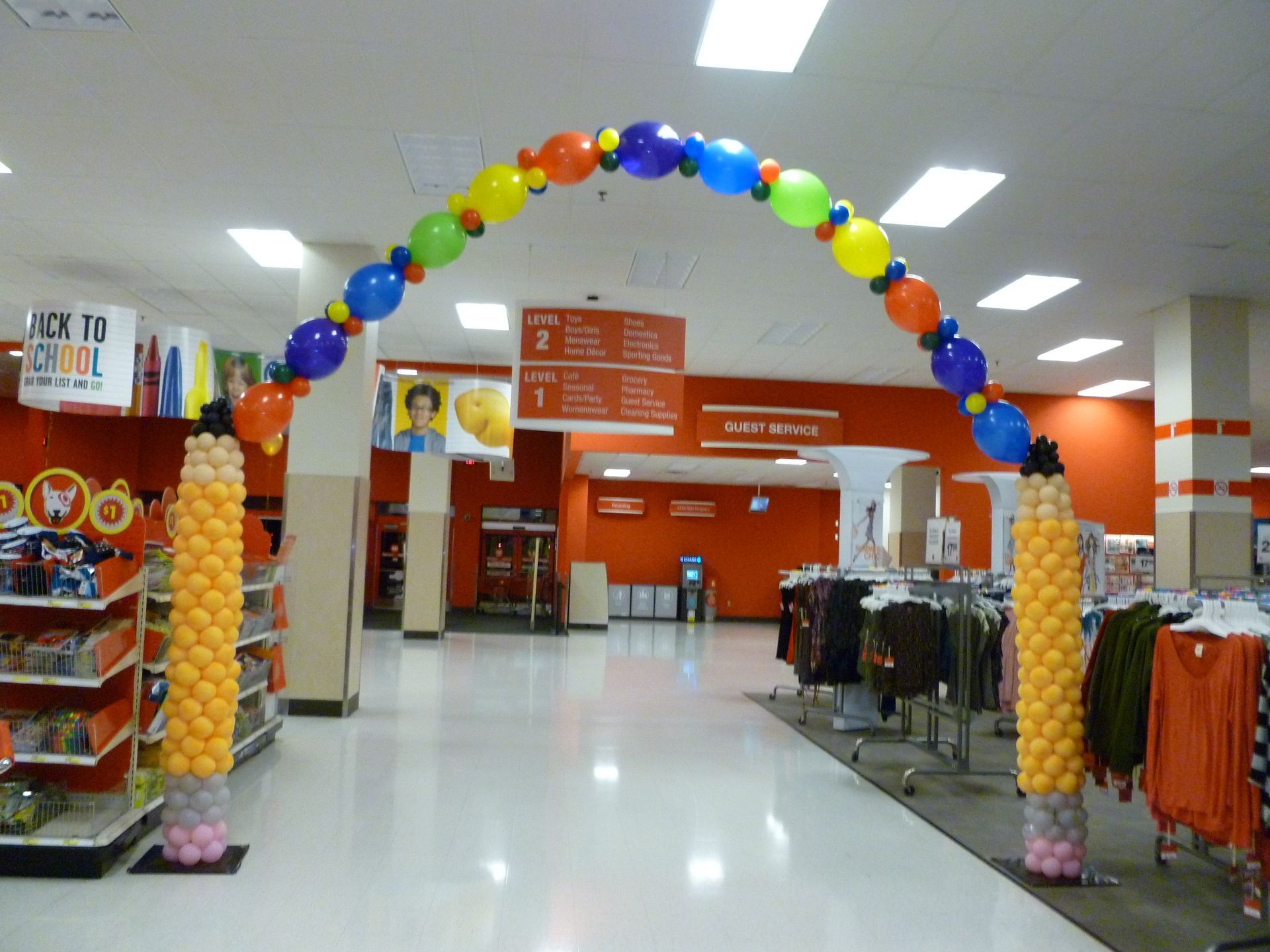 A store with balloons and a sign that says back to school