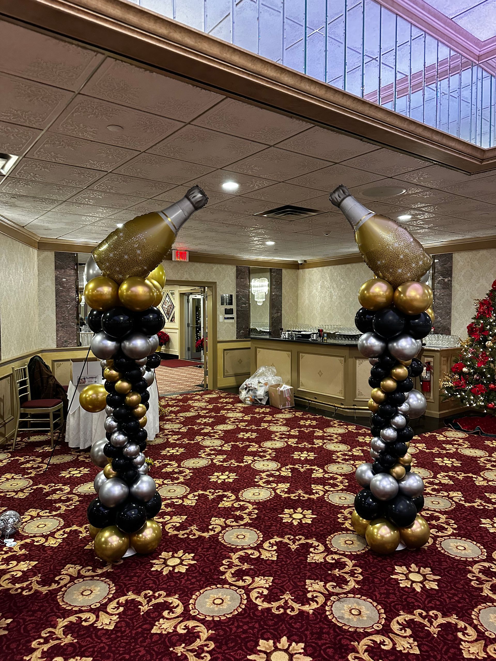 A room decorated with balloons and bottles of champagne.