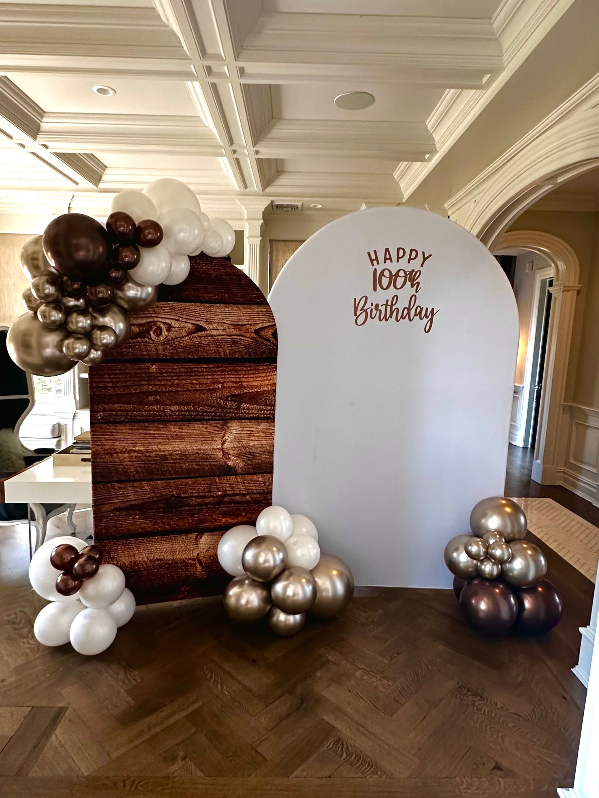 A room filled with balloons and a wooden wall.