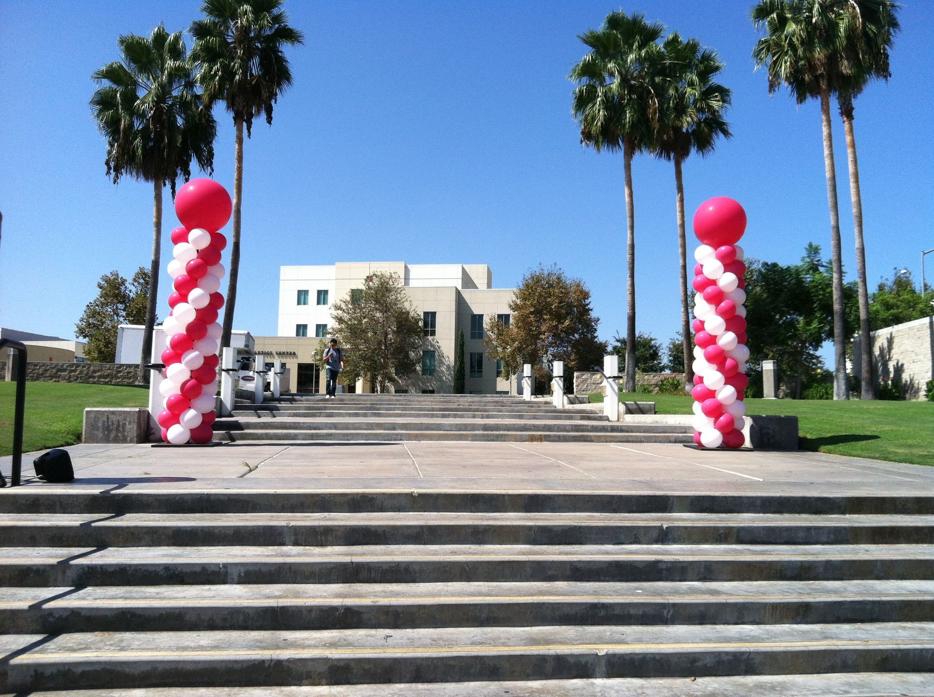 Red and white balloons on a staircase in front of a building