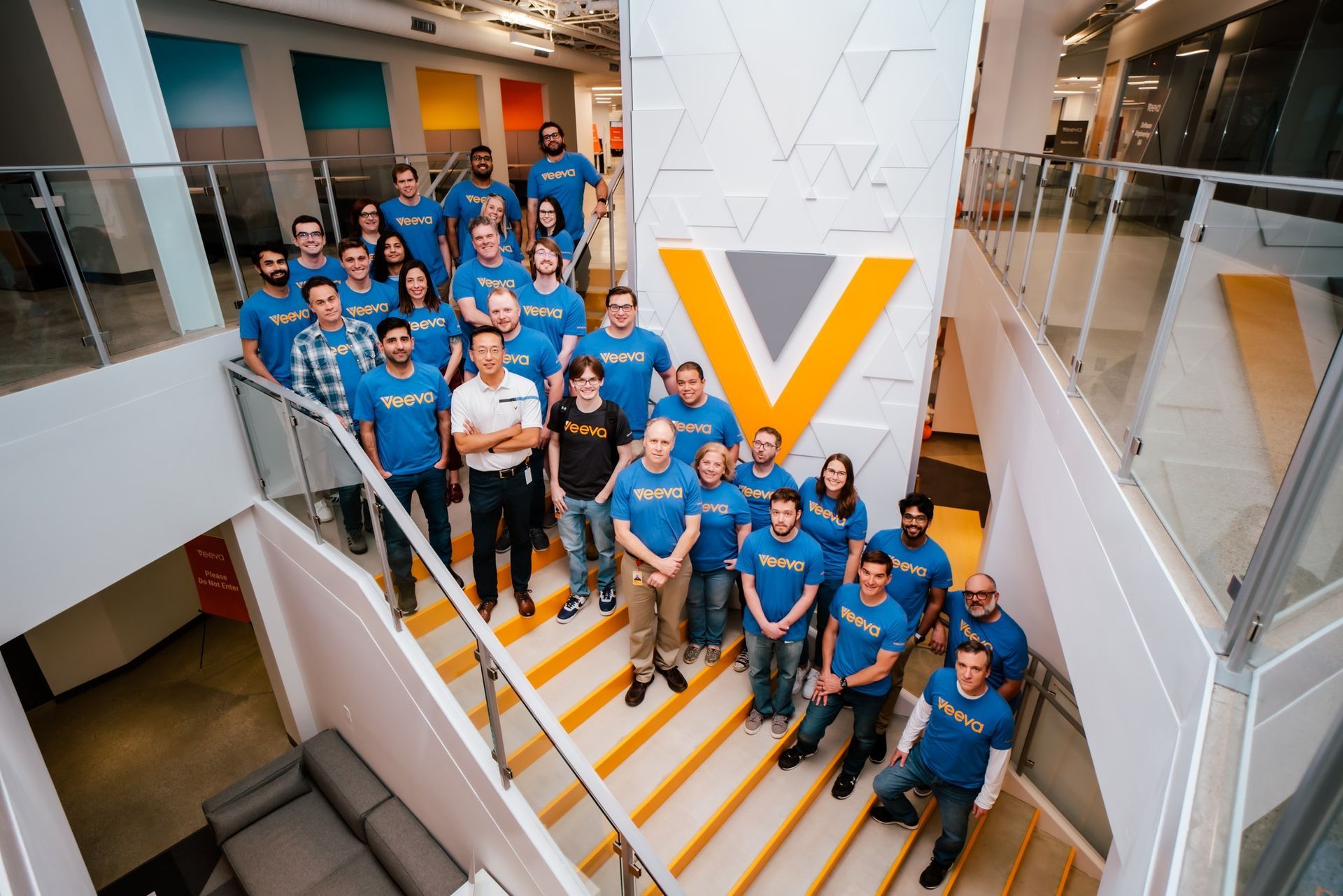 a group of people are posing for a picture on a set of stairs .