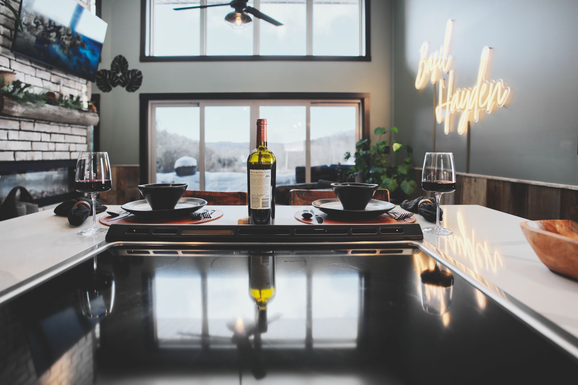 A bottle of wine is sitting on a counter in a kitchen.
