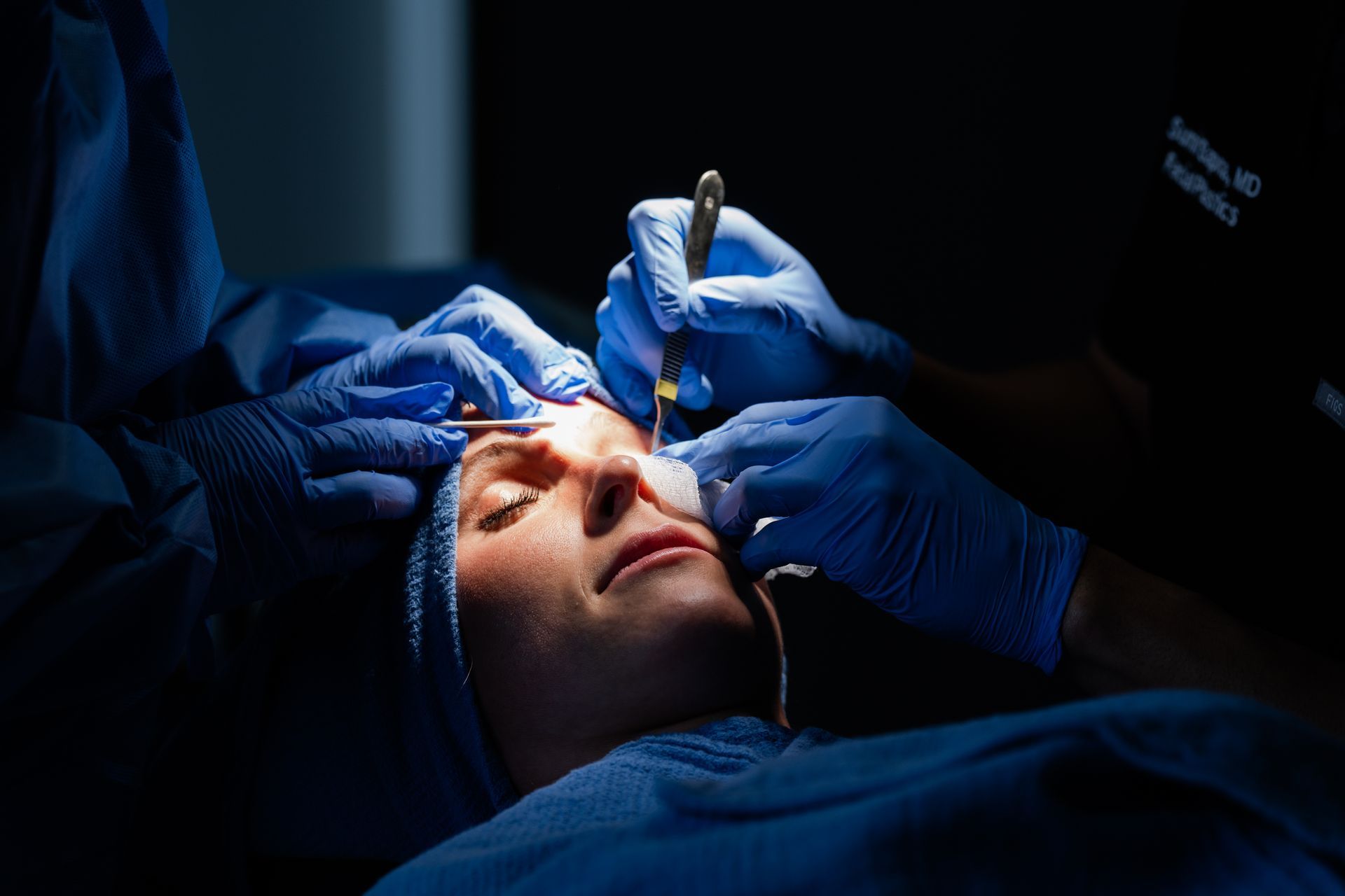A woman is being operated on by a surgeon in an operating room.