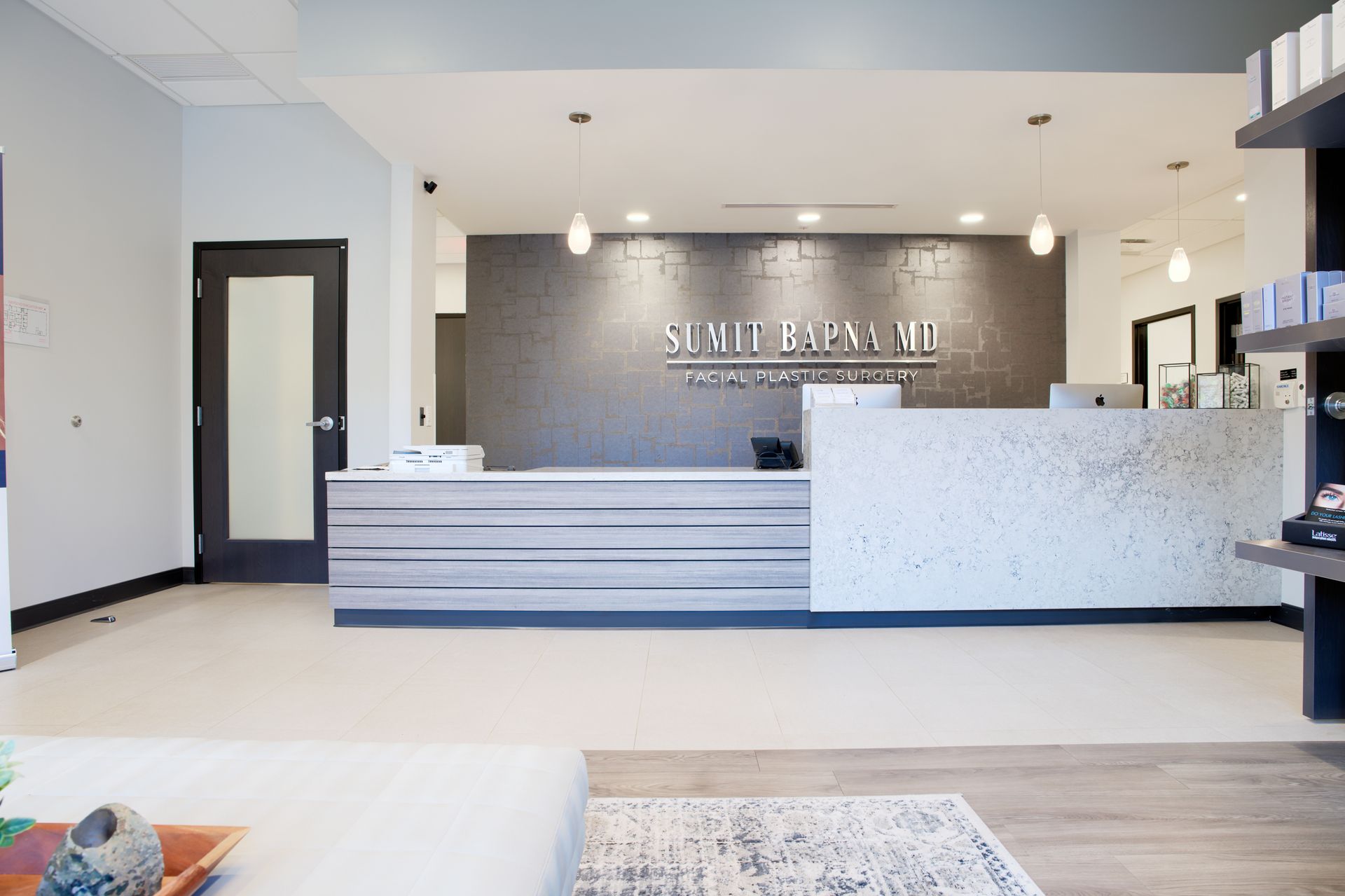 A dental office with a reception desk in the middle of the room.